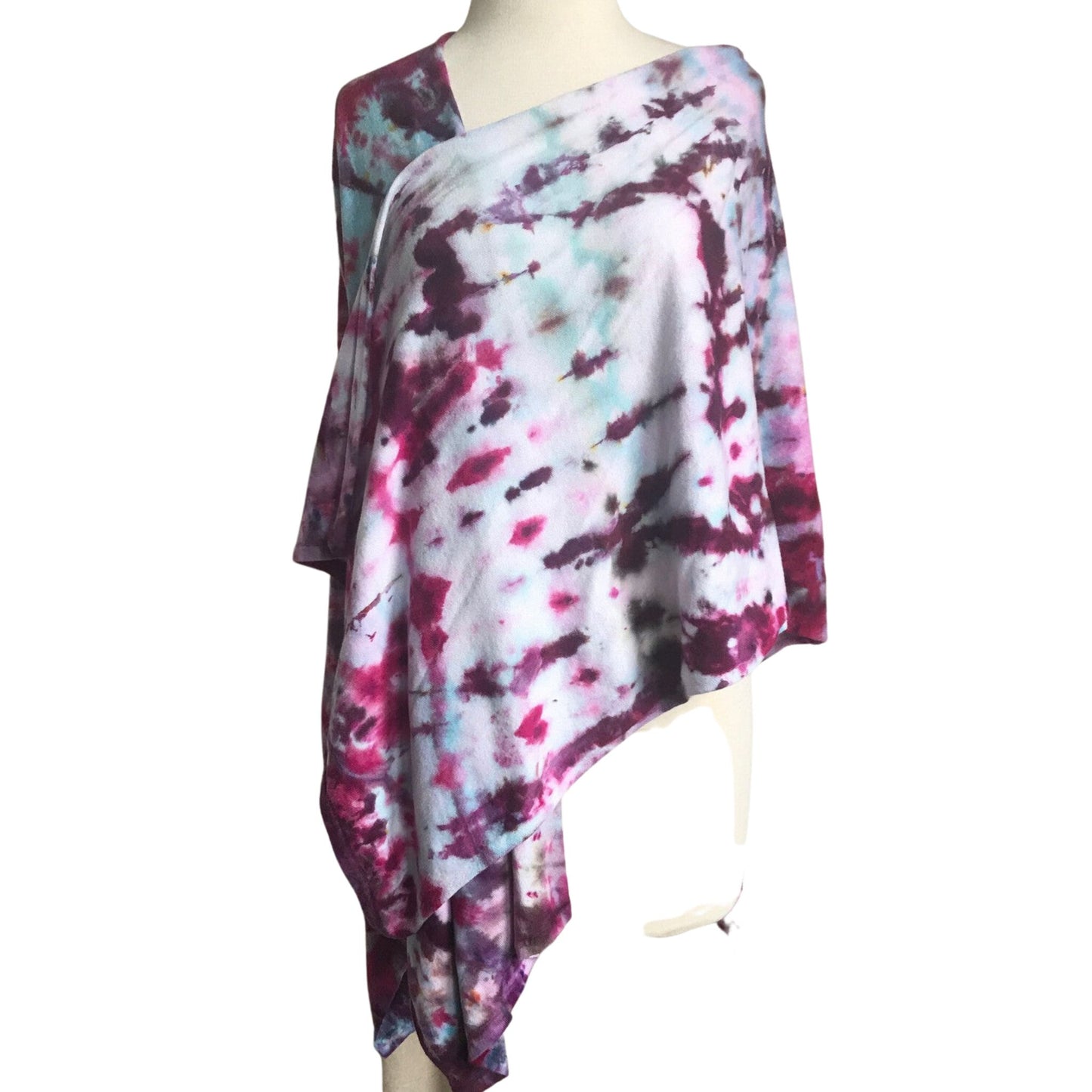 Front View of a Tie Dye Shawl wrapped around a dressform. The colors are turuoise and magenta in abstract irregular lines