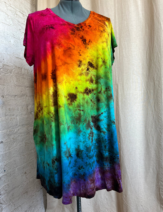 Short Sleeve Dress with diagonal rainbow color tie dye, on a mannequine against a beige background
